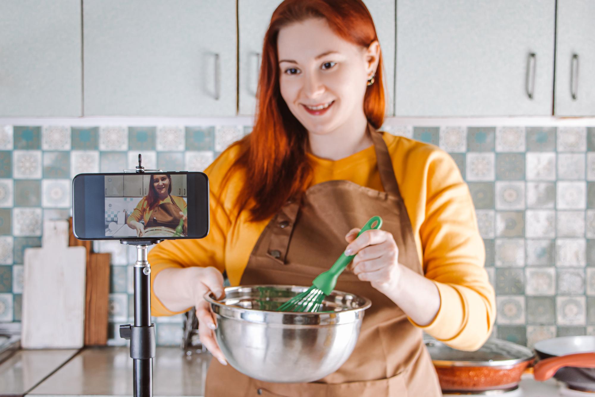 Small professional kitchen with instructor and student on video call