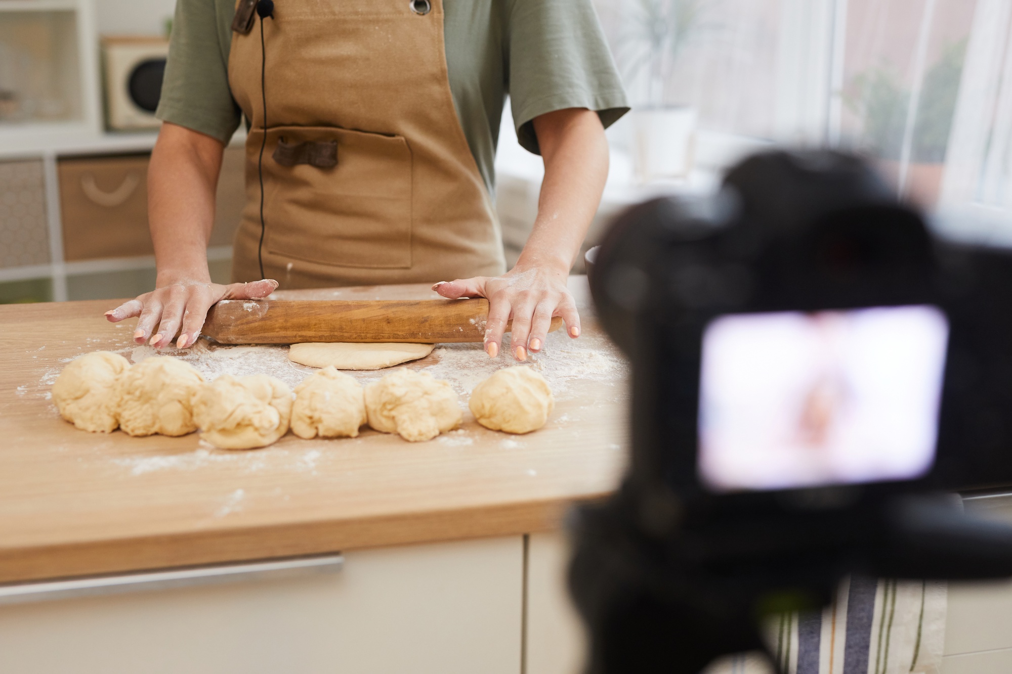 Instructor demonstrating dough technique on camera